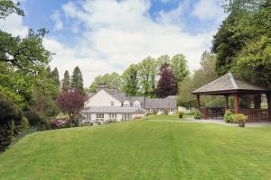 a large house with a gazebo in a yard at Briery Wood Hotel in Ambleside