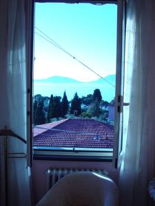 a window with a view of a soccer field at Locanda Miranda in Tellaro