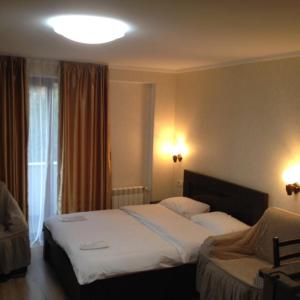 a hotel room with a bed and a window at David APT on Bakuriani Orbi Palace in Bakuriani