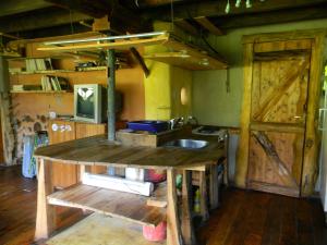 a kitchen with a wooden counter and a sink at Manon del Manantial in El Bolsón