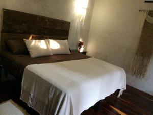 a bedroom with a large bed with a white blanket at La Flor Casa Boutique in Valladolid +27 photos