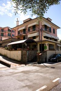 a building with a car parked in front of it at Locanda Miranda in Tellaro