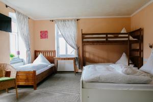 a bedroom with two bunk beds and a window at Landhotel Airport-Inn in Lautzenhausen