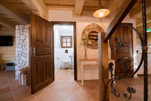 a hallway with a wooden door and a bathroom at Chata Zlata in Liptovská Štiavnica +50 photos