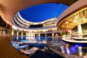 a large building with a swimming pool at night at Hue Hotels and Resorts Boracay Managed by HII in Boracay