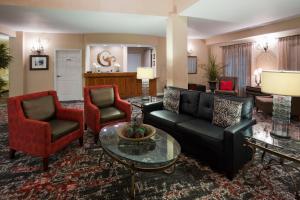 a living room with a couch and two chairs at GrandStay Residential Suites Hotel - Eau Claire in Eau Claire