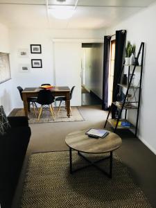 a living room with a table and a dining room at Cottage on Cork Steadman Cottage in Winton