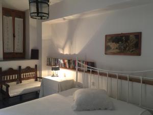 a bedroom with a bed and a table and a chair at Stephania's Stone House in Karyes