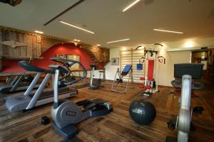 a gym with several exercise equipment in a room at Hotel Granta Parey in Rhêmes-Notre-Dame