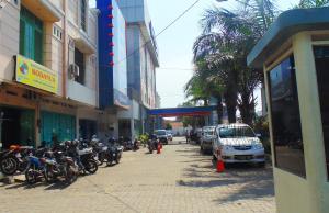 a group of motorcycles parked on a city street at Hotel Marlin Pekalongan in Pekalongan