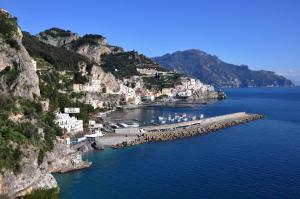 a group of houses on a mountain next to the water at Hotel Aurora in Amalfi