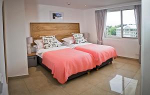 a bedroom with two beds and a window at The Quadrant Luxury Apartments in Victoria