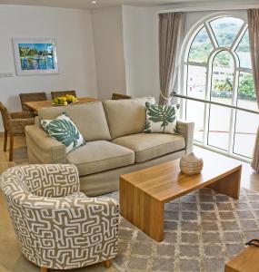 a living room with a couch and a table at The Quadrant Luxury Apartments in Victoria