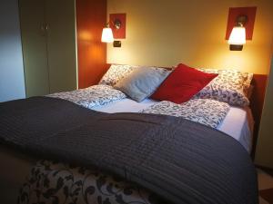 a large bed with pillows on it in a room at Giada in Moneglia