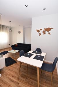 a living room with a table and a couch at Skanderbeg Square Center Apartments in Tirana