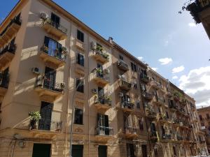 an apartment building with potted plants on the balconies at Eureka in Palermo
