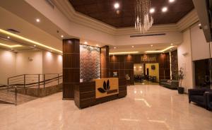 a lobby of a hotel with a chandelier at Lily Hotel Suite Mubarraz in Al Hofuf