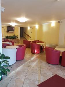 a restaurant with tables and chairs in a room at All Inclusive Hotel Piccolo Paradiso in Toscolano Maderno