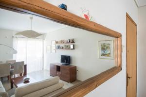 a living room with a couch and a dining room at Varkiza Apartment in Varkiza