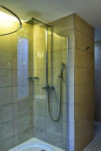 a shower with a glass door in a bathroom at Afrika Hotel Frýdek-Místek in Frýdek-Místek