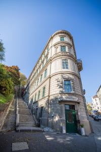 een groot stenen gebouw met een trap daarheen bij Logement Sous le Château in Boedapest