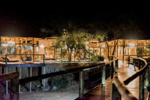a building with a garden at night at Moditlo River Lodge in Hoedspruit