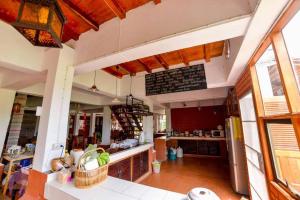 a large kitchen with a counter in a room at Huen Jam Rat in Mae Chaem