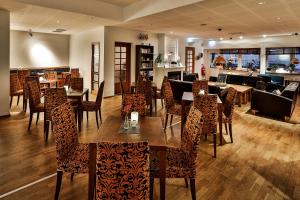 Un comedor con mesas y sillas en un restaurante. en First Hotel Jörgen Kock, en Malmö