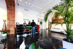 a lobby with people standing at the reception desk at Golden Triangle Boutique Hotel in Saint Petersburg
