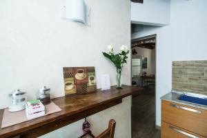 a kitchen with a counter with a vase of flowers at Villa Broglia House in Verona +37 photos