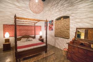 a bedroom with a bed and a dresser and a mirror at Ceylon Boutique Homestay Kandy in Kandy