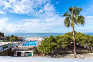 an aerial view of a resort with a swimming pool and a palm tree at Hotel Santa Caterina Village Club in Scalea