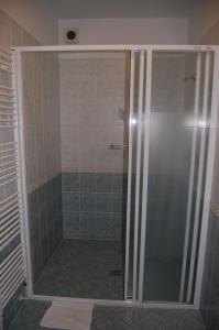 a shower with a glass door in a bathroom at Penzion U Zvonu in Nový Jičín