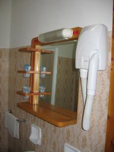 a bathroom with a hair dryer and a mirror at Hotel Prati in Castrocaro Terme