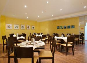 un restaurante con mesas y sillas en una habitación en Callas am Dom en Colonia
