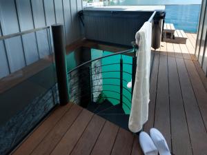 a towel hanging from the side of a wooden deck at Parkhotel Gunten – Beach & Spa in Gunten