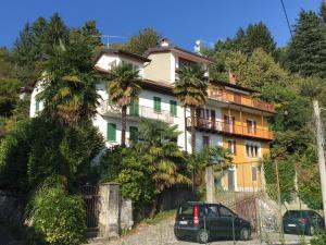 a house with palm trees in front of it at Tower 44 in Luino