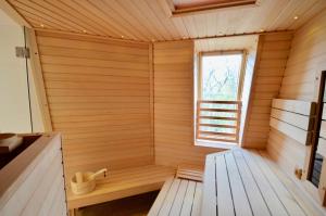 a wooden sauna with a window in a room at Villa Strandblick 10 in Zingst