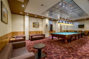 a large room with a pool table in it at Skyport Hotel in Ob