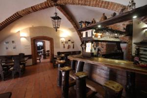 a bar in a restaurant with a counter and chairs at Zamek Reszel in Reszel
