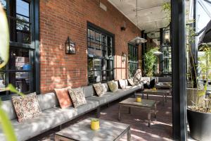 a brick building with a couch and tables at Oranje Hotel Leeuwarden in Leeuwarden