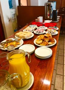 
a table topped with plates of food and drinks at Altoparque Hotel Salta in Salta
