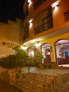 a building with stairs in front of it at night at Altoparque Hotel Salta in Salta