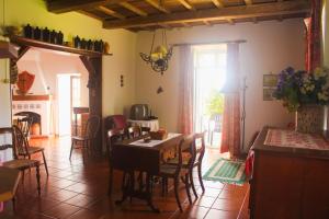 una cucina e una sala da pranzo con tavolo e sedie di Casa das Lapinhas a Lagoa