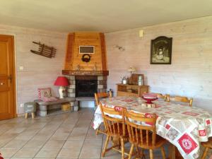 a dining room with a table and a fireplace at Gite Le Paradis in Saint-Nabord