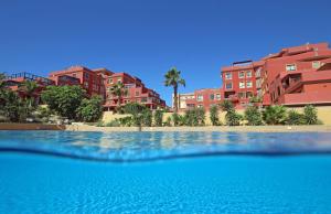 a swimming pool in front of some apartment buildings at LA PERLA by RENTMEDANO superb luxury duplex, private roof terrace, ocean view, pool, WiFi and parking in El Médano