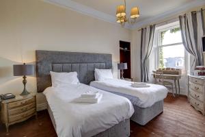 Postel nebo postele na pokoji v ubytování Bayswell Park Hotel