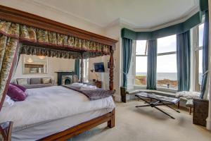 a bedroom with a large bed with a canopy at Bayswell Park Hotel in Dunbar