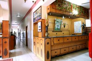 a room with wooden paneled walls and a lobby at Hotel Suriyapriya in Cuddalore