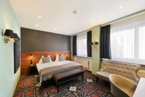 a hotel room with a large bed and a large window at Hotel City Zürich Design & Lifestyle in Zurich